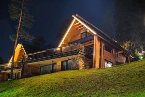 a house on top of a hill at night at Apartament Białka SKI - 200m do Term Bania, blisko natury in Białka Tatrzańska