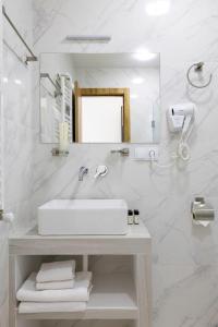 a white bathroom with a sink and a mirror at 3100 Boutique Hotel Kazbegi in Kazbegi +28 photos