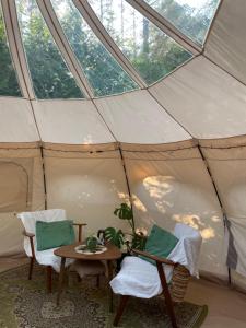a tent with two chairs and a table in it at TroldeSlottet in Rudkøbing
