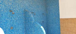 a blue tiled shower with a blue tile wall at Ocean front apartment Trianon in Daimuz +63 photos