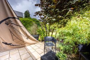 a chair sitting next to a tent in a garden at La p’tite barque de Saint-Malo in Saint Malo