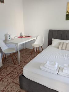 a bedroom with a bed and a table and chairs at "Spyros" 1-Room Apartment - Simple, cozy, close to the beach in Kato Daratso