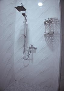 a shower with a shower head in a bathroom at SAIDA Family Guest House in Samarkand
