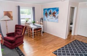 a living room with a table and a chair at Signegarden in Skjåk +7 photos