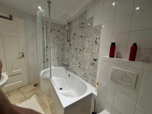 a white bathroom with a tub and a sink at Historic Town Luxe and Epic View in Clausen +23 photos