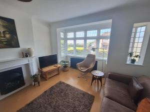a living room with a couch and a fireplace at Elegant Home SW16 Near Station Views Flexible Beds in Streatham Vale