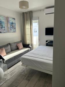 a living room with a bed and a couch at Loft Barbate in Barbate