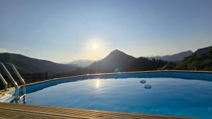 a swimming pool with a view of a mountain at CA Granja Paraíso, Oasis Rural & Bienestar in Cangas de Onís
