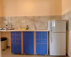 a kitchen with a sink and a refrigerator at Chris Apartment in Ksamil