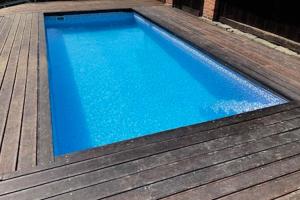 a large blue swimming pool on a wooden deck at Beskýdek III in Krásná