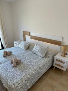 a bedroom with a bed with flip flops on it at El Balcón de Carrascoy, Wifi rápido, escritorio y parking ,15 min del centro de Murcia in Corvera