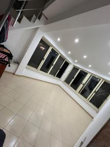 a room with windows and a tiled floor at Vila Oron in Vlorë
