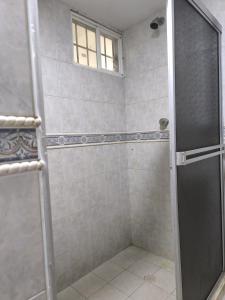 a shower with a glass door in a bathroom at CasaNegreteHostalBoutique in Cartagena de Indias +42 photos