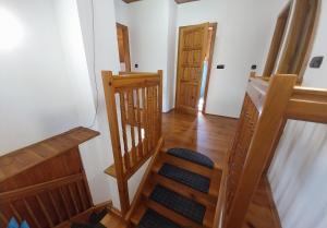 a staircase in a room with wooden floors and wooden doors at Chalupa u rybníčku in Doksy