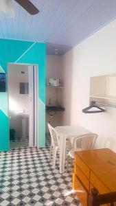 a dining room with a table and white chairs at Suites do Rafa Ubatuba in Ubatuba +24 photos