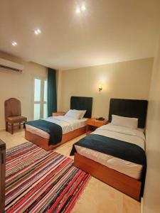 سرير أو أسرّة في غرفة في Kush Hotel, Grand Museum & Pyramids View