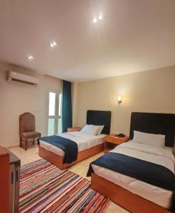 سرير أو أسرّة في غرفة في Kush Hotel, Grand Museum & Pyramids View