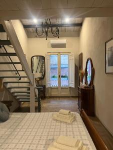 a bedroom with a bed and a staircase with a mirror at Vecchia Sicilia in Gela