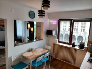 a kitchen with a table and chairs and a window at Ovidiu's dream in Constanţa