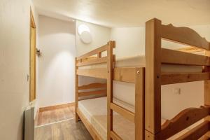 a bedroom with two bunk beds in a room at Appartement en résidence Belle Plagne Savoie in Belle Plagne +9 photos