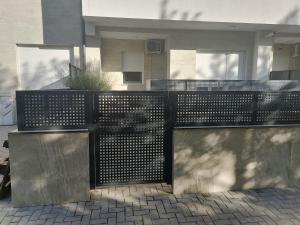 a metal fence in front of a house at LoKA apartman in Paraćin