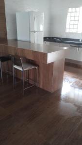 a large wooden table with two chairs in a room at Jardim Secreto in Piumhi