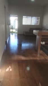 an empty room with a wooden floor and a table at Jardim Secreto in Piumhi +11 photos