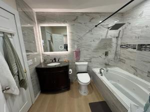 a bathroom with a tub and a toilet and a sink at 5 Star Vacation Home in Ely Sleep 6 in Ely +17 photos