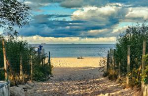 a beach with a person laying on the sand at Seaside Apartment in Gdańsk