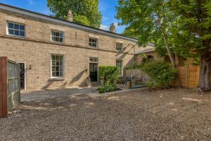a brick house with a gate and a fence at New - Luxury Suffolk Stay in Beccles