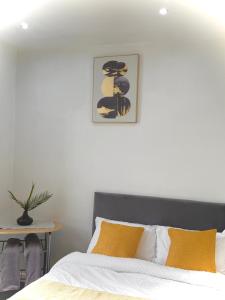 a bedroom with a bed and a picture on the wall at Oakbridge Studios in Burnley
