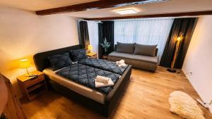 a living room with a couch and a chair at Lakeside Olti Apartment near Interlaken in Bönigen