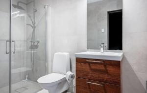 a bathroom with a toilet and a sink and a shower at Modern villa close to sea & nature! in Örnsköldsvik +10 photos