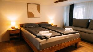 a bedroom with a bed with two towels on it at Lakeside Lela Apartment near Interlaken in Bönigen