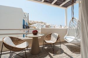 a room with two chairs and a table on a balcony at Castellum Suites in Naxos Chora