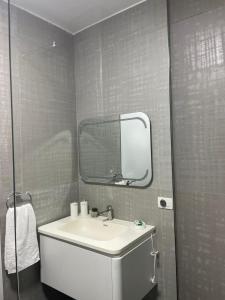 a bathroom with a sink and a mirror at Dolce Mare Luxury Apartment in Shëngjin +23 photos