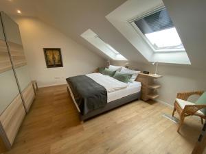 a attic bedroom with a bed and a skylight at Ferienwohnung im Burgecken in Mettlach