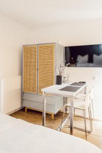 a white dining room with a white table and chairs at Alpenrausch 3 in Kiefersfelden +5 photos
