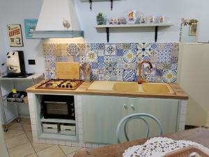a small kitchen with a sink and a stove at Mare Incanto in Gragnano +7 photos
