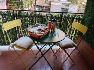 a table with a basket of food and two chairs at Mare Incanto in Gragnano