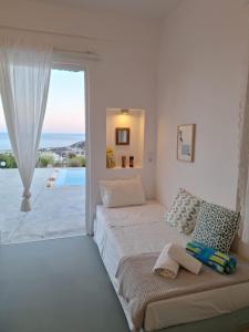 a bedroom with two beds and a large window at Villa Constantinos in Koutsounari +41 photos