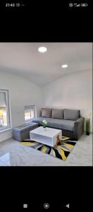 a living room with a couch and a coffee table at Apartman Centar Visegrad in Višegrad