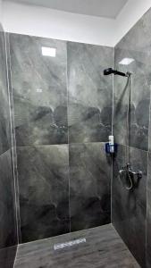 a shower with a glass door in a bathroom at Sweet Home in Pogradec
