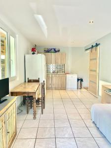 a kitchen with a table and a refrigerator at Appartement Risoul in Risoul