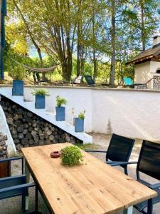 a wooden table with plants on top of a patio at Appartement Risoul in Risoul
