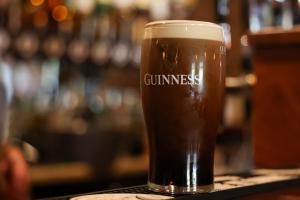 a glass of beer sitting on a bar at The Gables in Carland