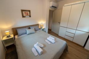 a bedroom with a bed with two towels on it at Apartman Ulika&Foška in Pazin