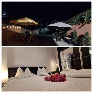a bedroom with a white bed and an umbrella at Ana's Garden Sibiu in Sibiu