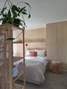 a bedroom with a bed and a wooden ladder at 't Holtslag in Baak