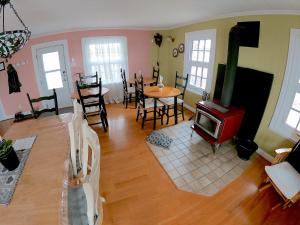 a living room with a stove and a table and chairs at Chez Caro et Sylvain in Rimouski